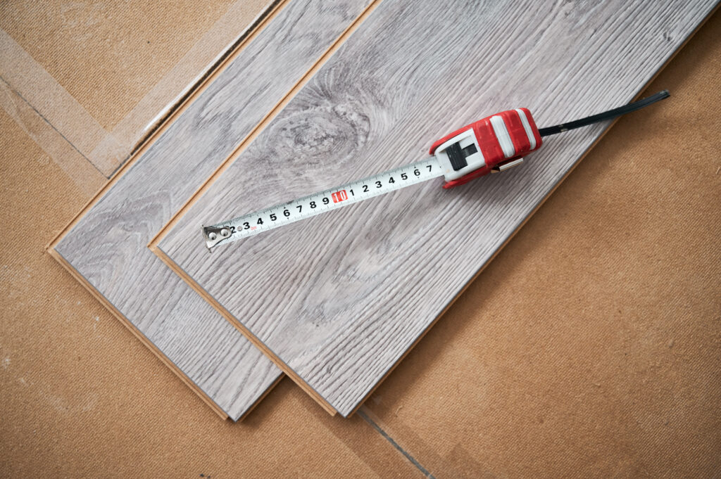 Samples of laminate timber planks with tape measure.
